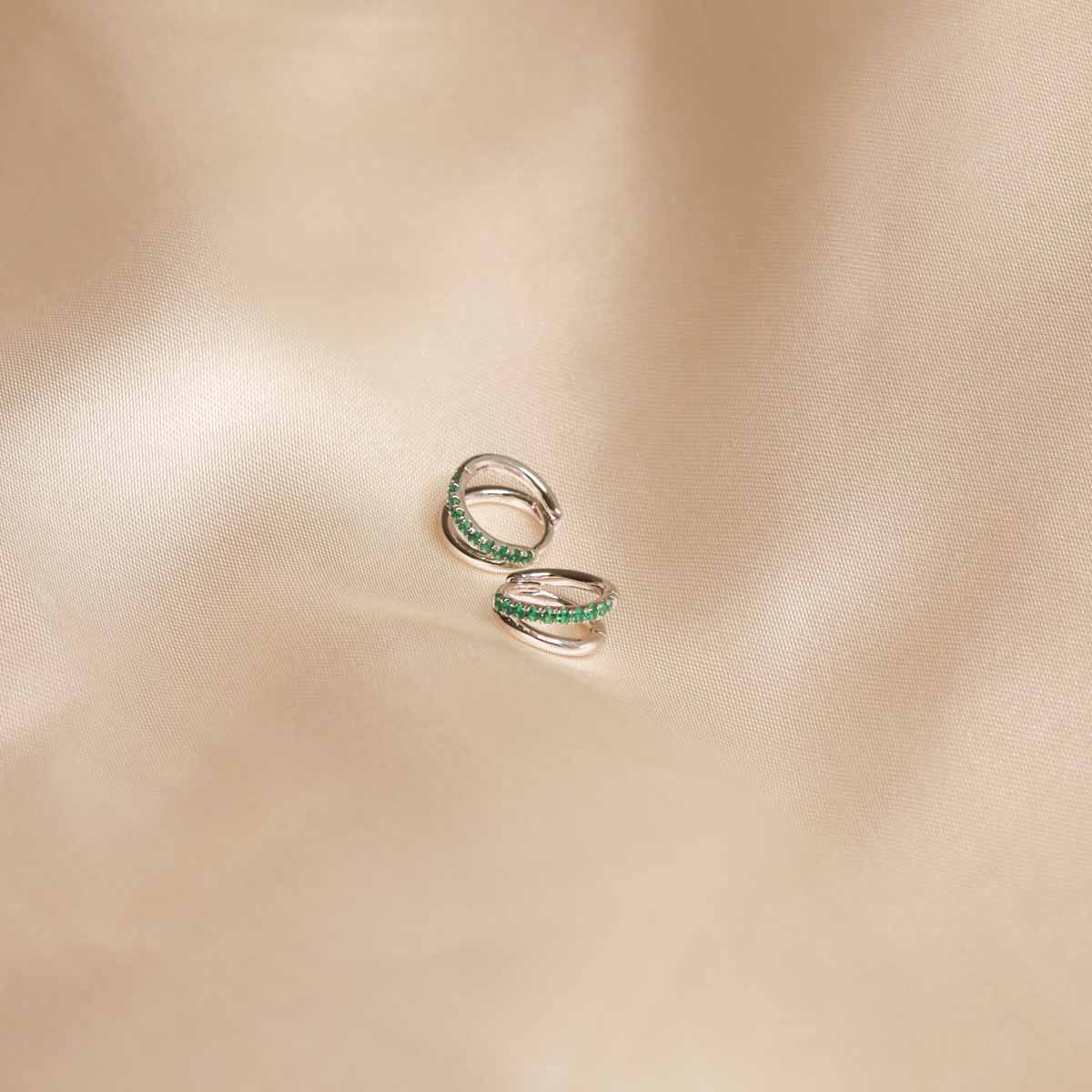 Flat lay shot of Duo Emerald Hoops in Silver