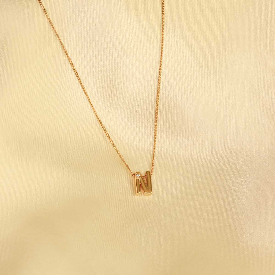 Flat lay shot of N Initial Pendant Necklace in Gold