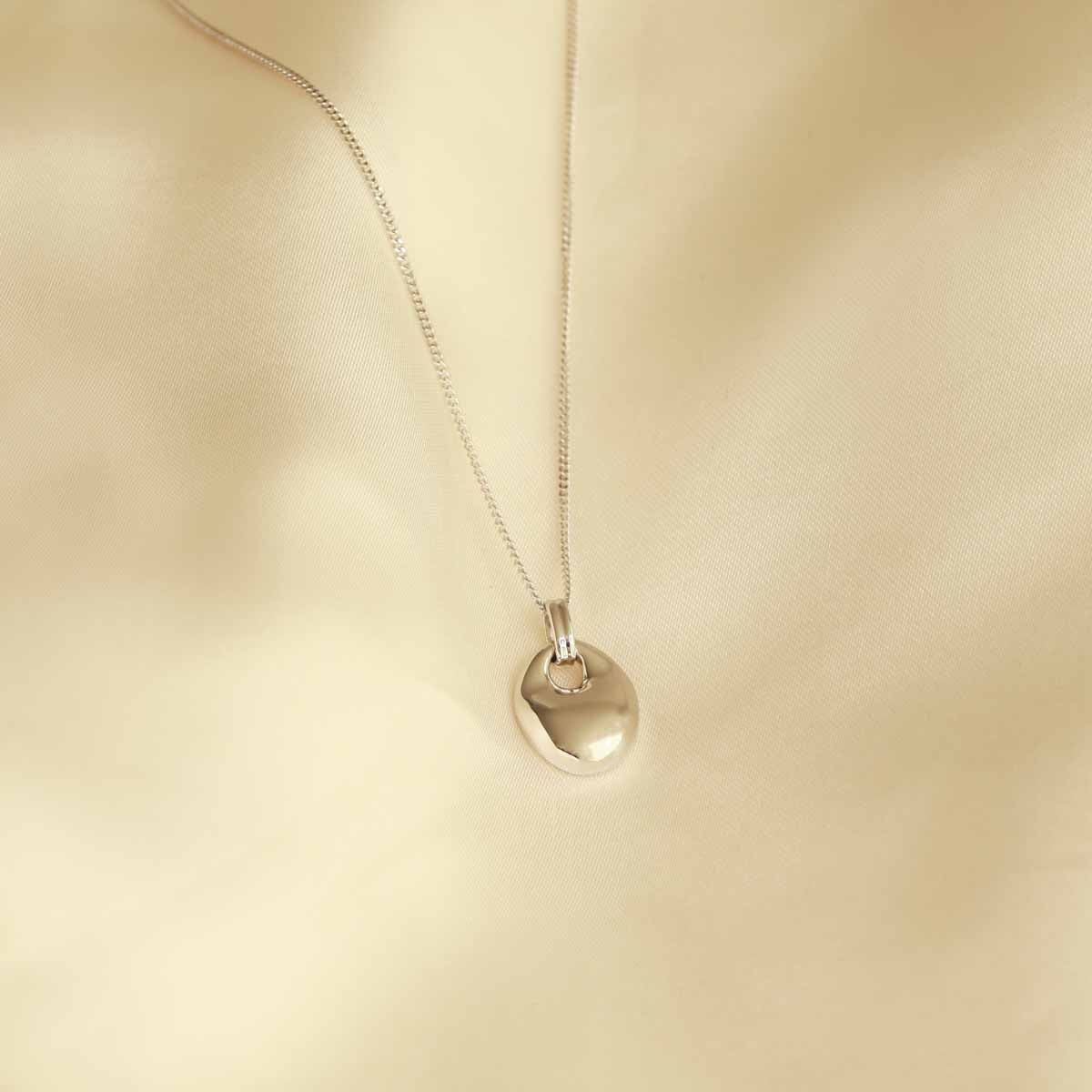 Flat lay shot of Essential Pendant Necklace in Silver